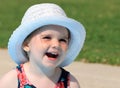 Young girl in white hat in the garden