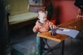 Young child playing with colorful markers on a wooden table indoors Royalty Free Stock Photo
