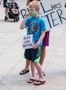 A Child Wearing a Mask Holds a Black Lives Matter Sign Royalty Free Stock Photo