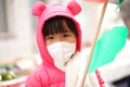 Child wearing a mask outdoors during an outbreak