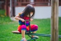 Child wearing mask is playing with downed horse. Girl played playground equipment. Prevent spread of coronavirus and PM2.5 dust.