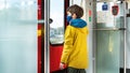 A child wearing a mask rides on public transport during the COVID 19 pandemic. A boy wearing a medical mask rides in an electric