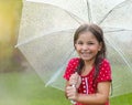 Child with wearing polka dots dress under umbrella Royalty Free Stock Photo