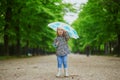 Child wearing rain boots with umbrella on a fall day Royalty Free Stock Photo