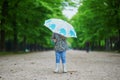 Child wearing rain boots with umbrella on a fall day Royalty Free Stock Photo