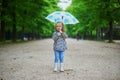 Child wearing rain boots with umbrella on a fall day Royalty Free Stock Photo