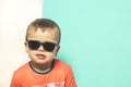 Child wearing sunglasses with a serious attitude