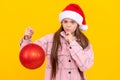 child wearing warm clothes. happy new year. merry christmas. serious kid in santa claus hat.