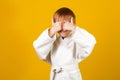 Child wearing white kimono. Happy karate kid. Healthy sporty childhood. Martial arts school Royalty Free Stock Photo