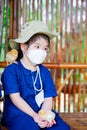 Child wearing white medical face mask. Kid holding chicken on her hands. Chick perched on shoulder little girl. Royalty Free Stock Photo