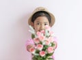 The child wears a hat and holding roses flowers with smiling and happy Royalty Free Stock Photo