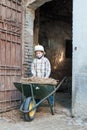 Child fixes a barrow with hay Royalty Free Stock Photo