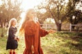 Child whirling, dancing plays on the meadow. Girl having fun with bubbles.