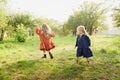 Child whirling, dancing plays on the meadow. Girl having fun with bubbles.