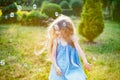 Child whirling, dancing plays on the meadow. Girl having fun with bubbles. Cute little longhair blonde girl dancing with soap Royalty Free Stock Photo