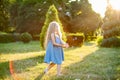 Child whirling, dancing plays on the meadow. Girl having fun with bubbles. Cute little longhair blonde girl dancing with soap Royalty Free Stock Photo