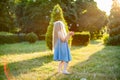 Child whirling, dancing plays on the meadow. Girl having fun with bubbles. Cute little longhair blonde girl dancing with soap Royalty Free Stock Photo