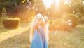 Child whirling, dancing plays on the meadow. Girl having fun with bubbles. Cute little longhair blonde girl dancing with soap Royalty Free Stock Photo