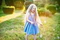 Child whirling, dancing plays on the meadow. Girl having fun with bubbles. Cute little longhair blonde girl dancing with soap Royalty Free Stock Photo