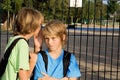 Child whispering at school