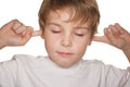 Child in white close eyes and ears Royalty Free Stock Photo