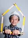 Child with white helmet and house