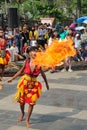 A child who is doing an attraction by spitting fire from inside his mouth at a festival in tmii