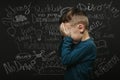 child whose depression is on a black background with his hands closed