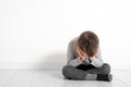 A child whose depression is sitting on the floor Royalty Free Stock Photo