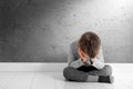 A child whose depression is sitting on the floor Royalty Free Stock Photo