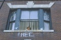 Child in window of residential project building, South Bronx, New York