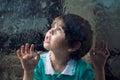 Child and window on a wet rainy day