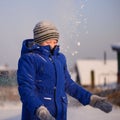 Child in winter clothes outside the city on the background of a