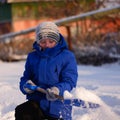 Child in winter clothes outside the city on the background of a Royalty Free Stock Photo