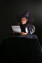 Child in wizard costume consulting his spell Royalty Free Stock Photo