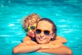 Child and woman playing in swimming pool