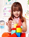 Child with wood block in play room. Royalty Free Stock Photo