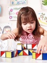 Child with wood block in play room. Royalty Free Stock Photo