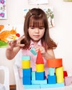 Child with wood block in play room. Royalty Free Stock Photo