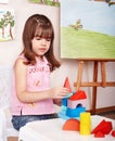 Child with wood block in play room. Royalty Free Stock Photo