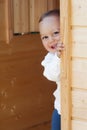 Child at wooden door Royalty Free Stock Photo