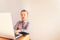 Child working business on his white laptop with surprise face Royalty Free Stock Photo