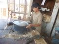 Child working in food shop in Pakistani village