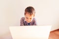 Child working with his computer in his business, concentrated typing to succeed, funny image Royalty Free Stock Photo