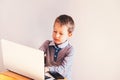 Child working with his computer in his business, concentrated typing to succeed, funny image Royalty Free Stock Photo