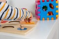 Child works with Montessori material for fine motor skills, sensory play. Playing children with geometry figures