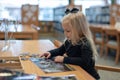 Child works on puzzle in library