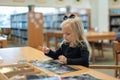 Child works on puzzle in public library Royalty Free Stock Photo