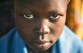 BOYA TRIBE, SOUTH SUDAN - MARCH 10, 2020: Child wrapped in blue cloth looking at camera while living in Boya Tribe