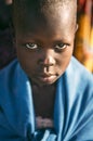 BOYA TRIBE, SOUTH SUDAN - MARCH 10, 2020: Child wrapped in blue cloth looking at camera while living in Boya Tribe village in